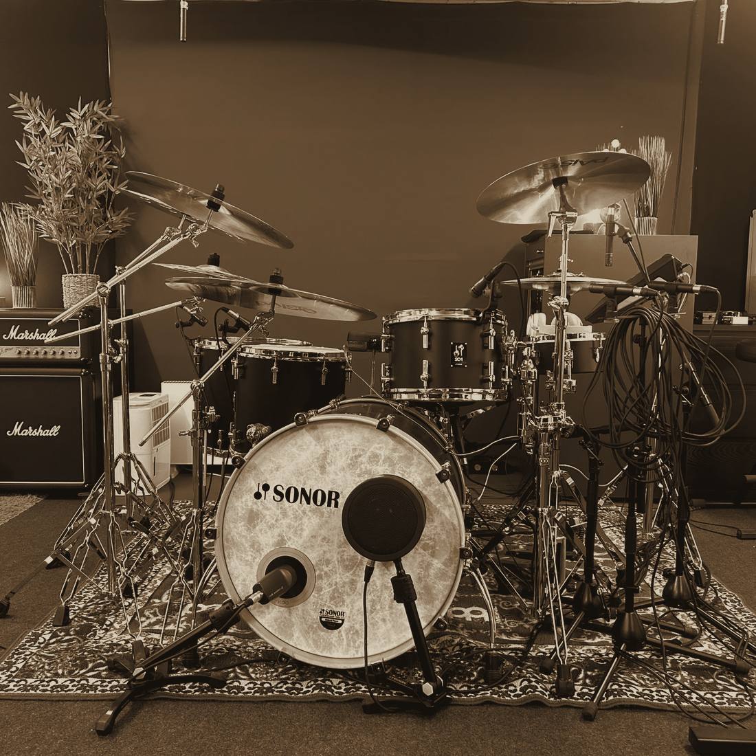 Microphone positioned above a cymbal